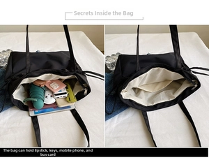 Interior detail of large capacity black tote bag showing zipper pockets and spacious layout