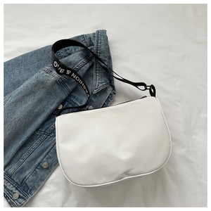 Detail of white half-moon shoulder bag with black 'FASHION & BAG' woven strap