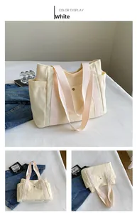 Detail view of large canvas tote bag in creamy white with pink handles and side pockets