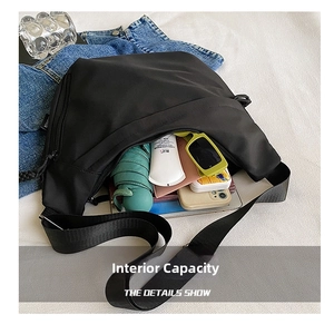 Top view of spacious black nylon crossbody bag showing interior storage for daily items