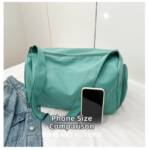 Close-up of green sports travel bag with waterproof nylon fabric and side zipper pocket