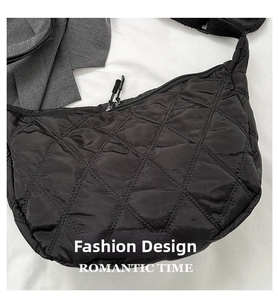 Close-up of black quilted nylon crossbody bag featuring diamond pattern and zip closure