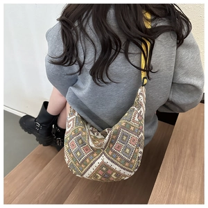 Ethnic canvas crossbody bag with colorful geometric patterns and adjustable yellow strap