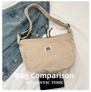 Detail of beige corduroy crescent bag showing BEAR woven label and texture on white fabric
