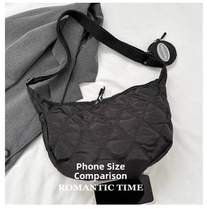Detailed view of quilted nylon crescent bag with a detachable round coin purse on the strap
