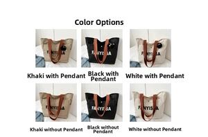 Detail view of large canvas tote bag showing color options with letter print and front pocket