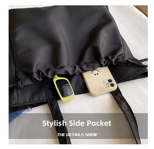 Close-up of waterproof tote bag side pocket with sunglasses and mobile phone inside