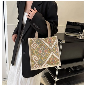 Close-up of geometric woven handbag with ethnic patterns and durable fabric handles