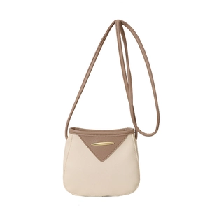 Minimalist beige and brown bucket bag with gold metal trim and adjustable strap