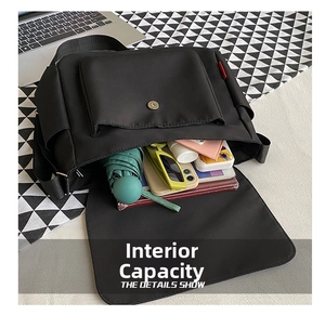 Detailed interior of a black nylon messenger bag showcasing its large storage capacity