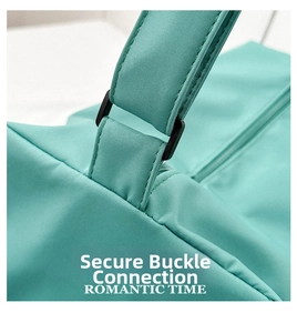 Detail of black plastic buckle connecting mint green oxford fabric handle and bag body