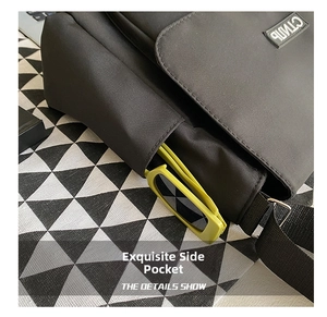 Close-up of functional side pocket on black crossbody bag with yellow sunglasses