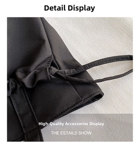 Detail shot of a black tote bag showing adjustable drawstring and twill fabric texture