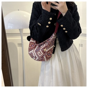 Ethnic woven canvas crossbody bag with red geometric pattern shown in a mirror selfie