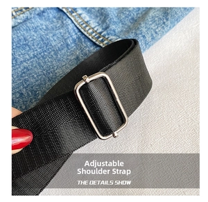 Detail of durable black nylon adjustable shoulder strap with silver metal buckle on bag