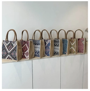 Detailed macro view of various ethnic tote bags showing colorful linen texture patterns