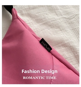 Detail of rose pink nylon bag showing fabric texture and black SPORT woven label tag