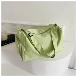Detail view of mint green travel bag featuring waterproof nylon and side zipper compartment