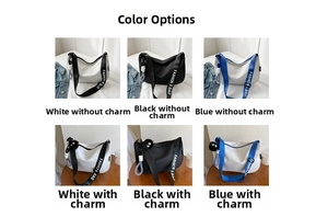 Detail view of canvas shoulder bags in white, black and blue with fashion strap