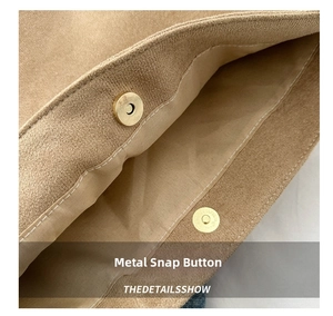 Detailed close-up of khaki suede bucket bag with gold magnetic buckle and fine stitching