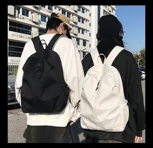 Detail of minimalist nylon backpack showing vertical zipper and side drawstring pockets