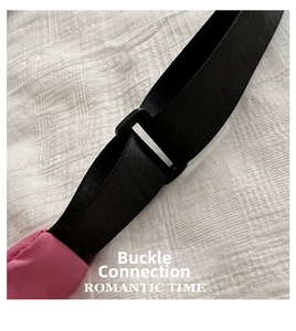 Detail of pink oxford fabric bag featuring adjustable black nylon strap and plastic buckle