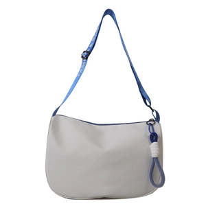 Minimalist white half-moon crossbody bag with blue logo strap and decorative knot charm