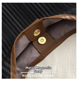 Detail view of gold magnetic closure on grey herringbone canvas tote bag with brown trim