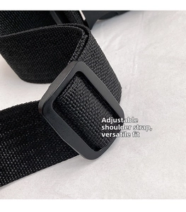 Close-up of the adjustable nylon shoulder strap with a matte black plastic buckle
