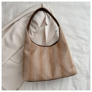 Close-up of the beige and brown vertical striped canvas texture on a stylish tote bag