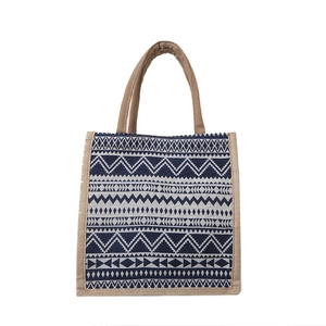 Geometric pattern woven tote bag with navy blue tribal shapes on a white background