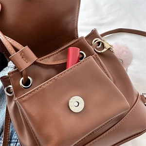 Retro brown leather mini backpack with metal magnetic closure and pink plush charm