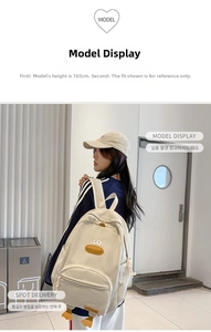 Detail of cute beige corduroy duck backpack with 3D cartoon eyes, beak and webbed feet