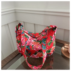 Detail of red floral canvas hobo bag with traditional Chinese peony and dragon patterns