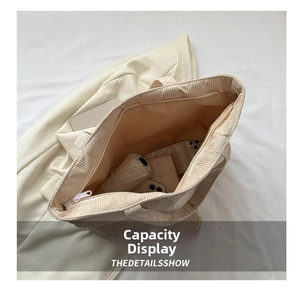 Top view of beige corduroy tote bag interior showing large capacity and zipper closure