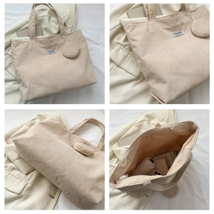 Detail of corduroy tote bag showing large capacity for umbrella and phone with a mini pouch