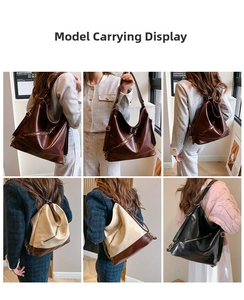 Detail view of retro soft leather bucket bag in dark brown and white colorblock