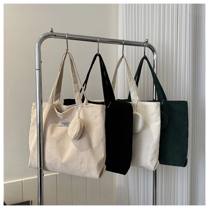 Corduroy tote bags in beige, black, white, and dark green with matching mini pouches