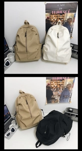 Detail view of large capacity nylon backpack in khaki, white and black for school