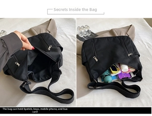 Detail showing inner compartments of a black canvas tote bag with multi-pocket storage