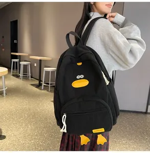 Detail of black corduroy cartoon duck backpack with embroidery and side pocket