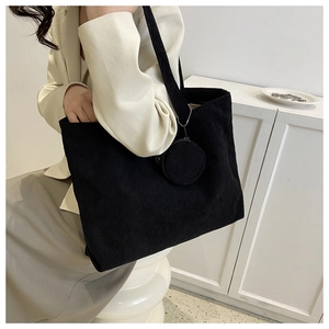 Detail of black corduroy tote bag with round coin purse and FASHION label