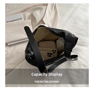 Detailed internal view showing large capacity of the black lychee pattern leather tote bag