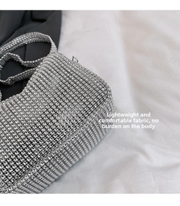 Close-up of sparkling silver rhinestone handbag with detailed mesh grid and thin strap