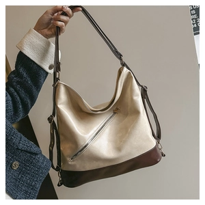 Detail of retro large capacity tote backpack with bicolor contrast and zipper accents