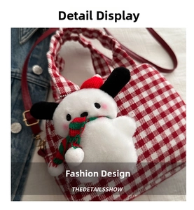 Detail of red gingham pattern fabric bag with a plush puppy charm and red leather strap