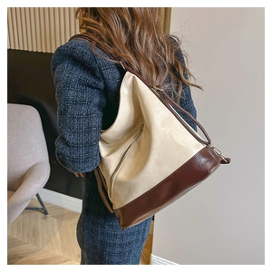 Detail view of the large capacity tote bag featuring color-blocking design and metal zipper