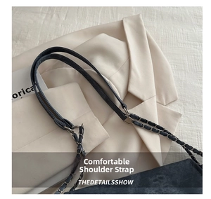 Detail of blue denim shoulder strap with silver metal chain on casual tote bag