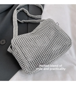 Detail of silver rhinestone mesh crossbody bag showing sparkling crystals and shoulder strap