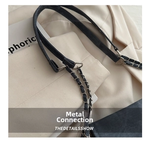 Macro shot of dark grey denim chain strap with round metal ring connection details